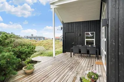 a wooden deck with a table and chairs on it at 897-Thisted-Nordsovej-46-C in Thisted