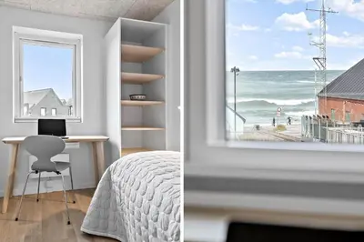 a bedroom with a window with a view of the ocean at 794-Thisted-Havstokken-26-1 in Thisted