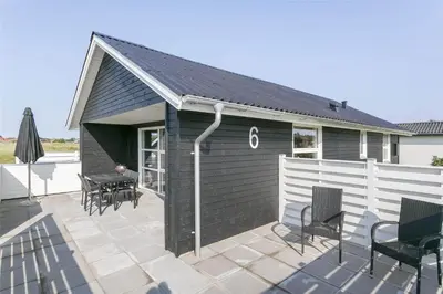 a patio with a pitched roof with chairs and a table at 736-Thisted-Kuttervej-6 in Thisted