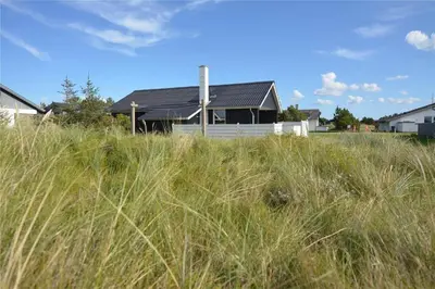 a house behind a field of tall grass at 736-Thisted-Kuttervej-6 in Thisted