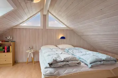 a bed in a room with a large window at 150-Thisted-Orredvej-32 in Thisted