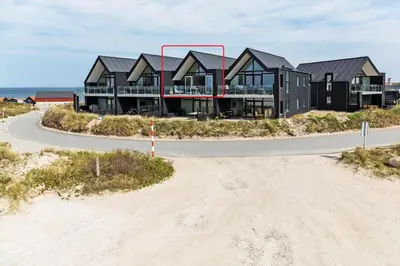a house on the beach with a road in front of it at 792-Thisted-Havstokken-22-1 in Thisted