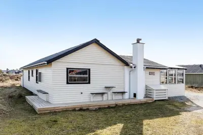 a white house with a deck with a table at 310-Thisted-Store-Knuds-Vej-7 in Thisted