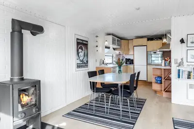 a kitchen and dining room with a table and a fireplace at 310-Thisted-Store-Knuds-Vej-7 in Thisted