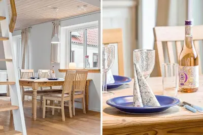 a kitchen and dining room with a table with a bottle of wine at 1017-Thisted-Hvidbakken-17 in Torsted