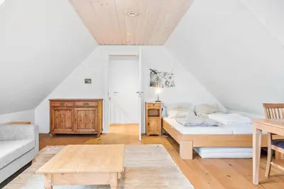 a living room with a bed and a table at 1017-Thisted-Hvidbakken-17 in Torsted