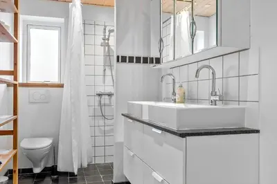 a white bathroom with a sink and a toilet at 1017-Thisted-Hvidbakken-17 in Torsted