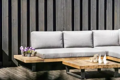 a couch and a coffee table with flowers on it at 1013-Thisted-Sine-Krokones-Vej-12 in Torsted