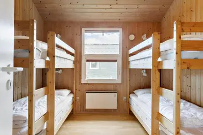 a room with three bunk beds in a cabin at 990-Thisted-Spanggardsvej-29 in Torsted
