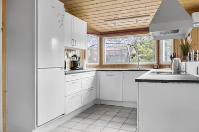 a kitchen with white cabinets and a wooden ceiling at 990-Thisted-Spanggardsvej-29 in Torsted