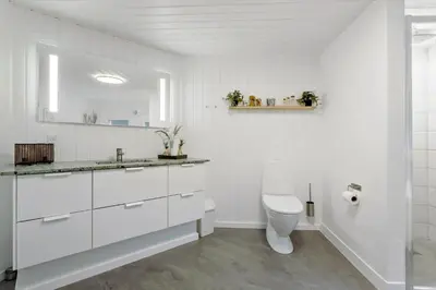 a white bathroom with a toilet and a sink at 990-Thisted-Spanggardsvej-29 in Torsted