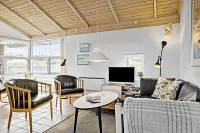 a living room with a couch and chairs and a tv at 273-Snedsted-Sarasvej-33 in Snedsted