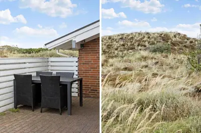 a patio with a table and chairs next to a field at 273-Snedsted-Sarasvej-33 in Snedsted