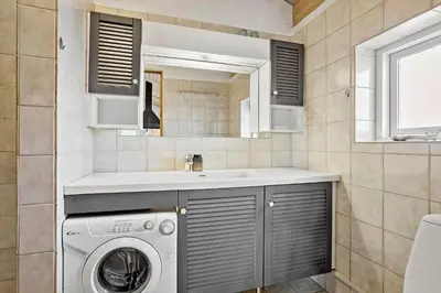 a bathroom with a washing machine and a sink at 273-Snedsted-Sarasvej-33 in Snedsted
