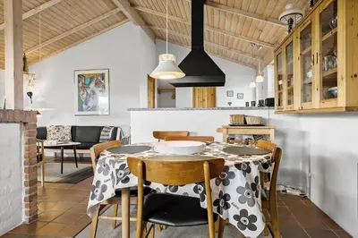 a kitchen and dining room with a table and chairs at 273-Snedsted-Sarasvej-33 in Snedsted