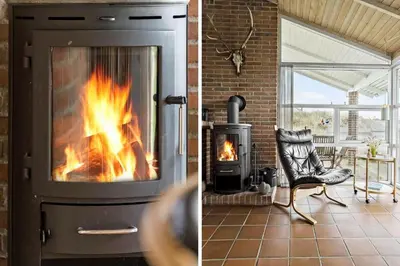 a fireplace in a living room with a chair and a stove at 273-Snedsted-Sarasvej-33 in Snedsted