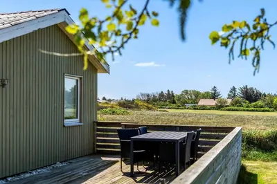 a table and chairs on the deck of a house at 149-Snedsted-Lykkens-Hab-39 in Snedsted