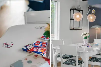 a bedroom with a table and a white bed and a table and chairs at 149-Snedsted-Lykkens-Hab-39 in Snedsted