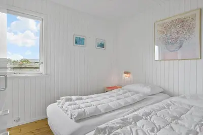 two beds in a white room with a window at 131-Thisted-Aerenprisvej-13 in Thisted