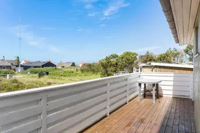 a balcony with a table on a wooden deck at 131-Thisted-Aerenprisvej-13 in Thisted