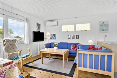 a living room with a blue couch and a table at 131-Thisted-Aerenprisvej-13 in Thisted
