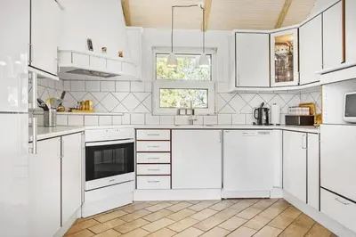 a white kitchen with white cabinets and appliances at 487-Thisted-Hummervej-9 in Thisted