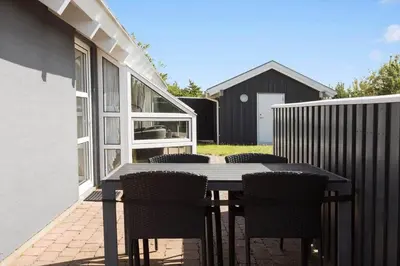 a table and chairs on a patio with a fence at 487-Thisted-Hummervej-9 in Thisted