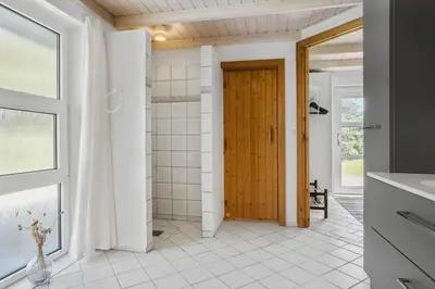 a bathroom with a shower and a wooden door at 487-Thisted-Hummervej-9 in Thisted