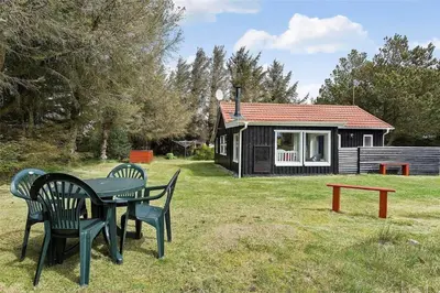 a table and chairs in front of a cabin at 630-Thisted-Kristinesvej-40 in Thisted