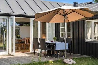 a table and chairs with an umbrella on a patio at 255-Thisted-Kraen-Knudsens-Vej-13 in Thisted