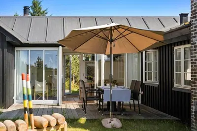 a patio with a table and an umbrella at 255-Thisted-Kraen-Knudsens-Vej-13 in Thisted