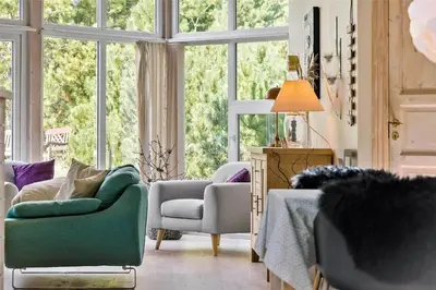 a living room with a couch and chairs and windows at 704-Thisted-Kristinesvej-54 in Thisted