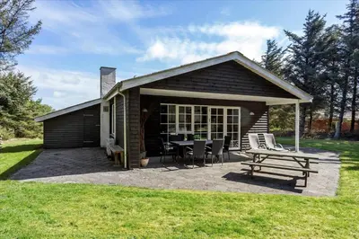 a small cabin with a picnic table and chairs at 406-Vestervig-Bekkasinvej-6 in Vestervig