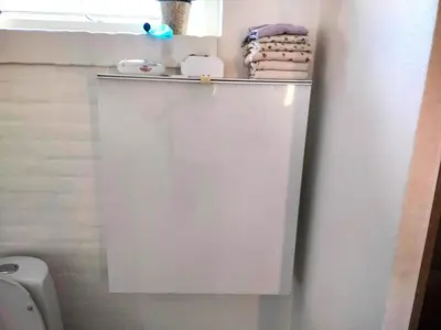 a white toilet with a shelf above it in a bathroom at 138-Thisted-Lervej-8-B in Thisted