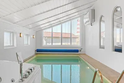 a swimming pool in a room with a large window at 652-Thisted-Orredvej-58 in Thisted