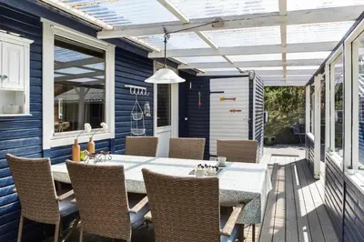 a patio with a table and chairs on a deck at 257-Thisted-Blamunkevej-34 in Thisted
