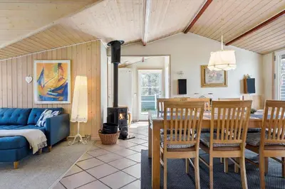 a living room with a table and a blue couch at 257-Thisted-Blamunkevej-34 in Thisted