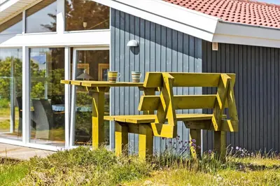 a yellow bench sitting in front of a house at 160-Thisted-Bredkaervej-33 in Thisted