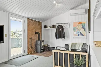 a living room with a chair and a stove at 160-Thisted-Bredkaervej-33 in Thisted