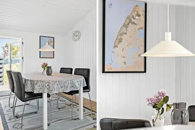 a dining room with a table with chairs and a map at 160-Thisted-Bredkaervej-33 in Thisted