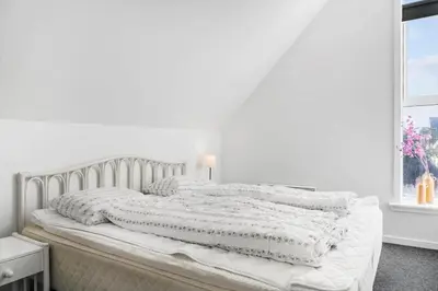 a white bed with white sheets and a window at 541-Thisted-Nordsovej-49 in Thisted