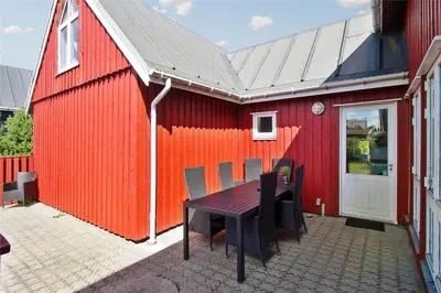 a red building with a table and chairs next to it at 541-Thisted-Nordsovej-49 in Thisted
