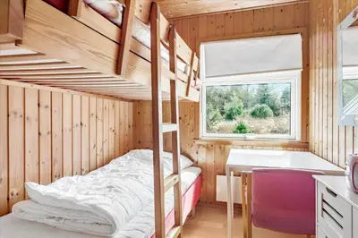 a bedroom with bunk beds and a desk and a window at 337-Thisted-Hummervej-11 in Thisted