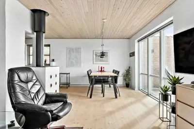 a dining room with a table and a chair at 264-Vestervig-Krik-Strandvej-20 in Vestervig