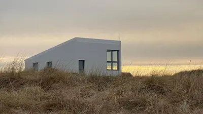 a white building sitting on top of a hill at 302-Snedsted-Klitfogedvej-7 in Snedsted