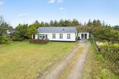 a white house in a field with a dirt road at 800-Thisted-Nordsovej-41 in Thisted