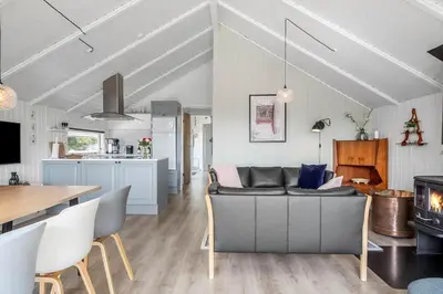a living room and kitchen with a couch and a table at 620-Thisted-Pighvarvej-20 in Thisted