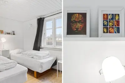 a bedroom with two beds and a window at 893-Thisted-Vesterhavsgade-148 in Thisted