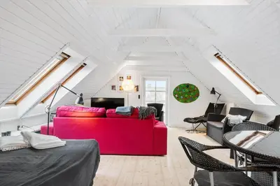a living room with a red couch in a attic at 893-Thisted-Vesterhavsgade-148 in Thisted