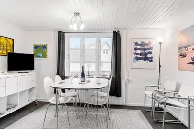 a white dining room with a table and chairs at 893-Thisted-Vesterhavsgade-148 in Thisted
